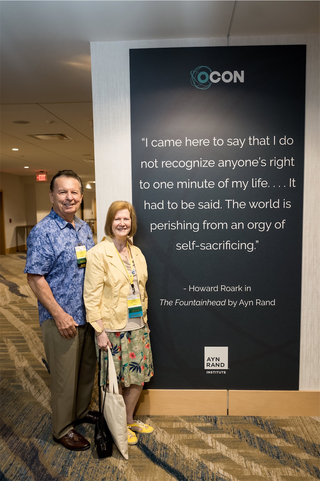 OCON attendees pose by quote from The Fountainhead